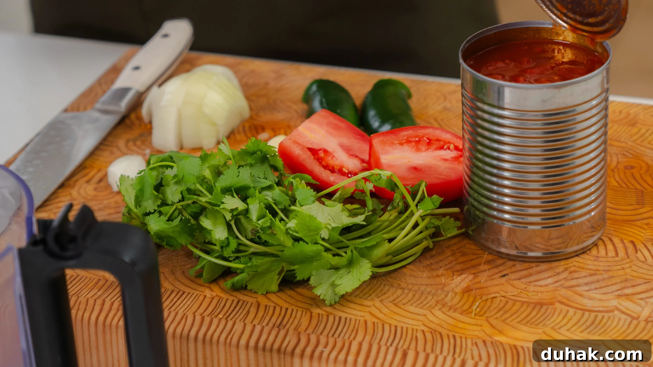 Homemade salsa ingredients in a cutting board.