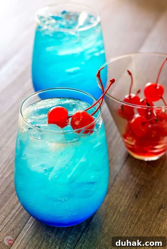 Space Pop Cocktail with Cherries on a wood surface