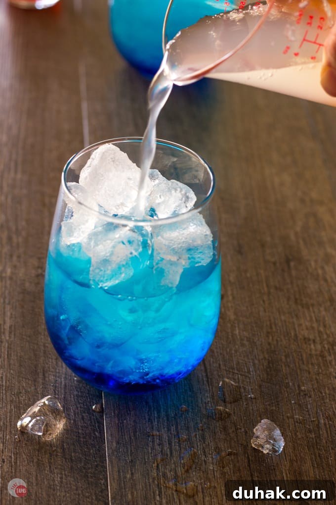 Slowly pouring the limeade mix in to Astro Pop Cocktail