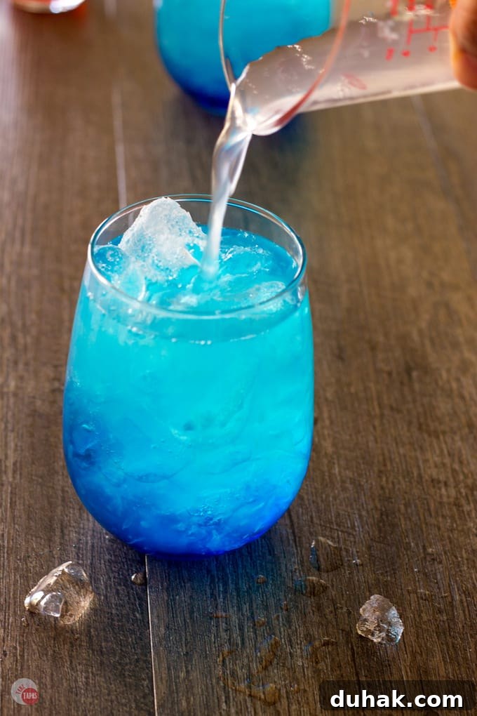 pouring the Vodka in the Astro Pop Cocktail into a glass