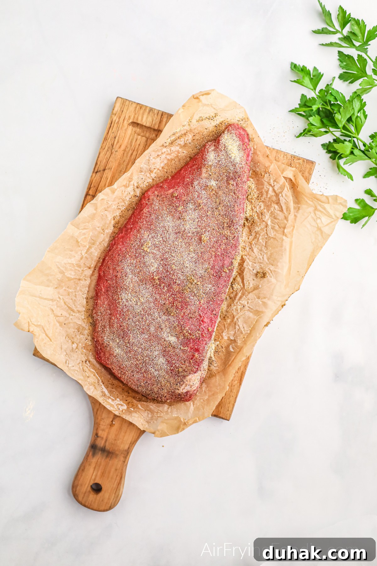 Seasoned and raw London Broil ready to be air fried.