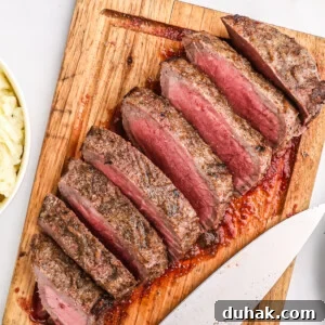 Air fryer London broil sliced and served on a cutting board, ready to eat.