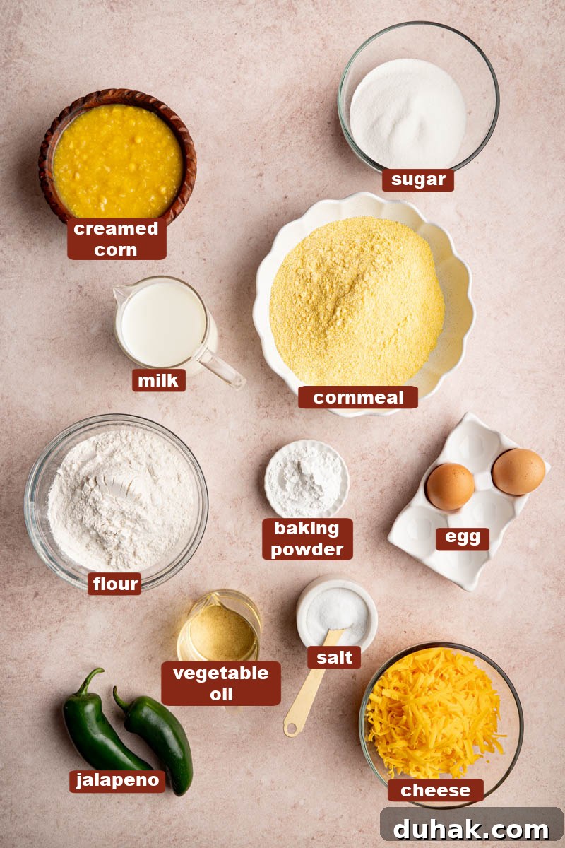 All of the ingredients for jalapeno cheddar cornbread in bowls on a countertop.