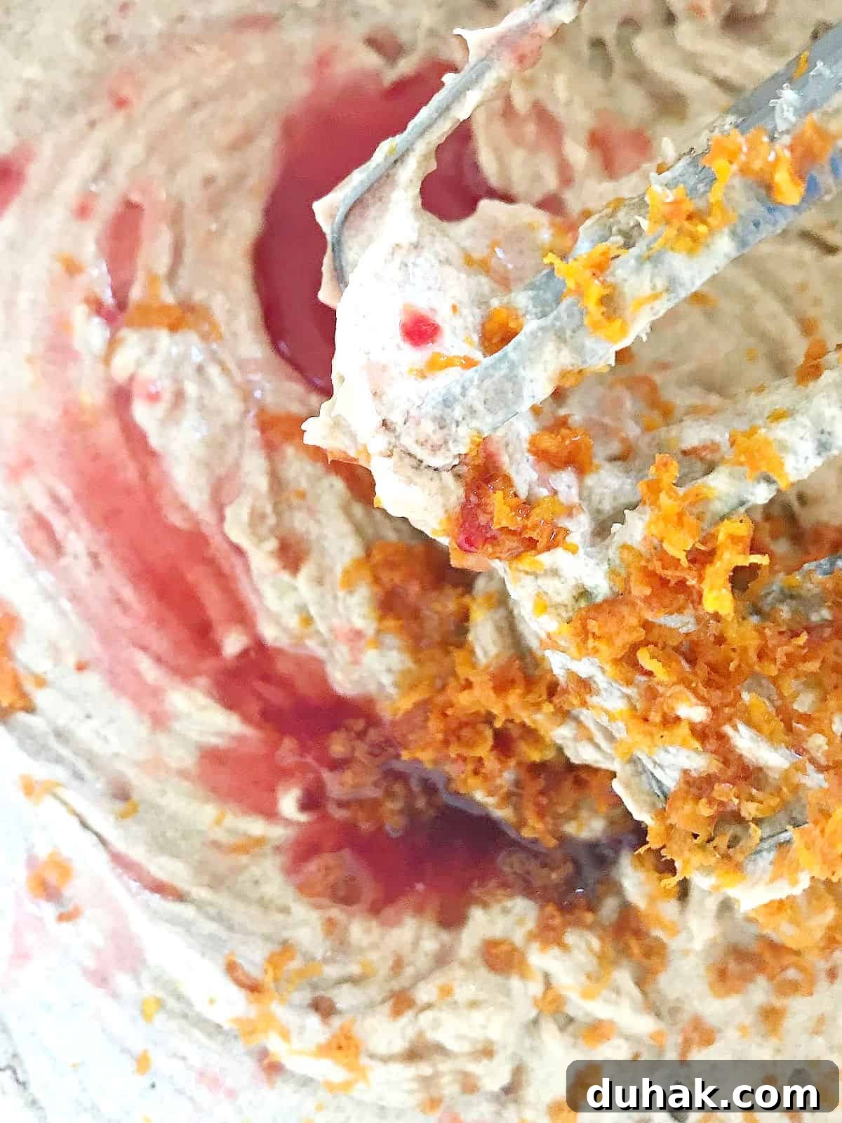 Close up of cake batter with blood orange juice and zest.
