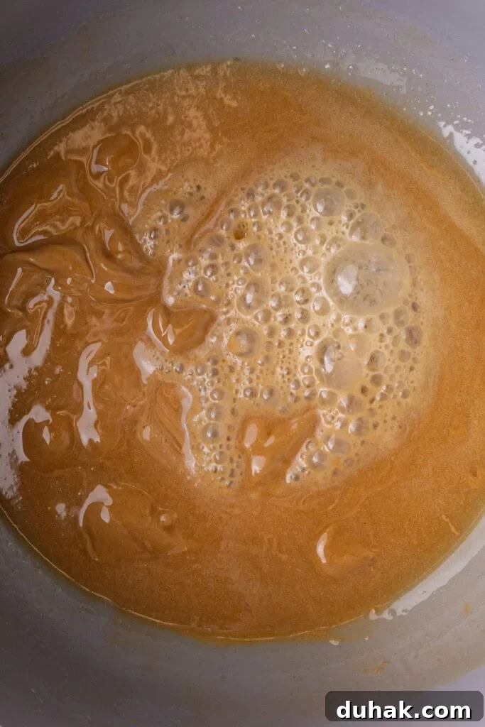 Peanut butter and melted unsalted butter combined and bubbling in a large pot.