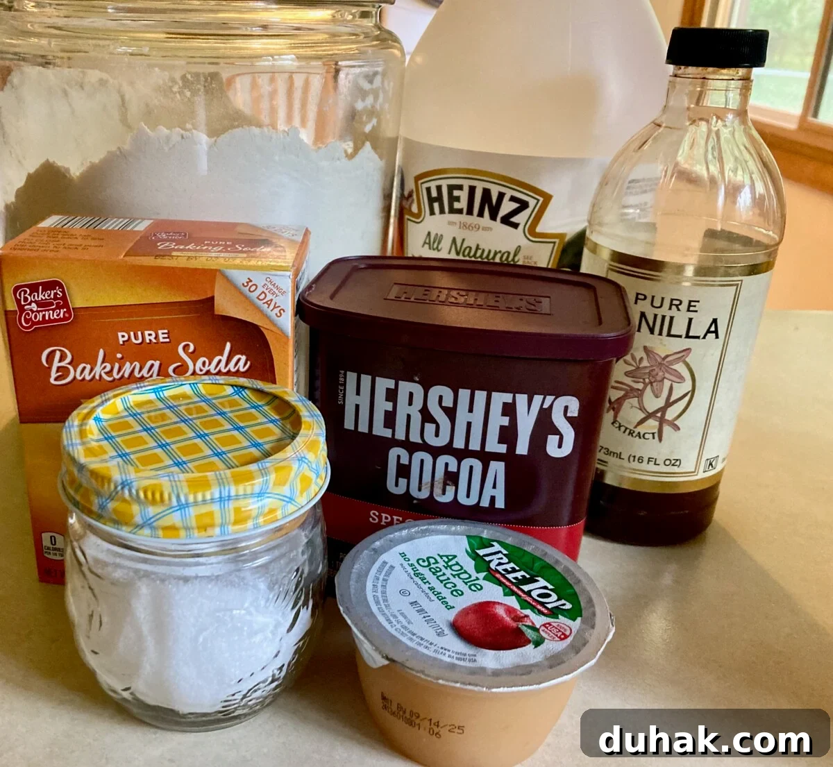 Eggless Wacky Cake Recipe — No Butter, No Milk Needed 3 Chocolate Depression Cake ingredients including. all-purpose flour, cocoa powder, vanilla extract, vinegar, baking soda, salt, applesauce and water.