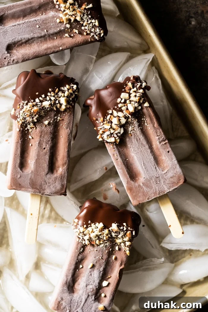 Keto chocolate popsicles dipped in chocolate and almonds