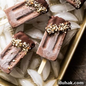 Keto chocolate popsicles dipped in chocolate and almonds