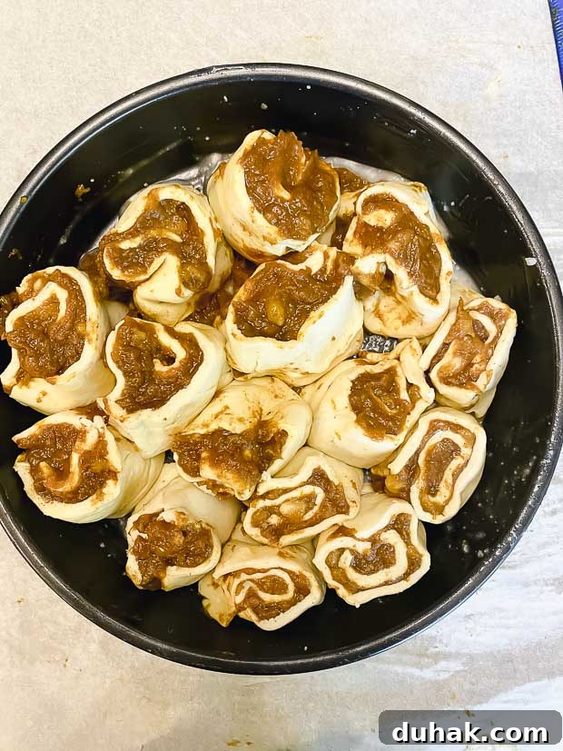 Maple-Banana Pumpkin Cinnamon Rolls with Warm Cinnamon Glaze 9 Cut unbaked cinnamon buns in a round baking pan
