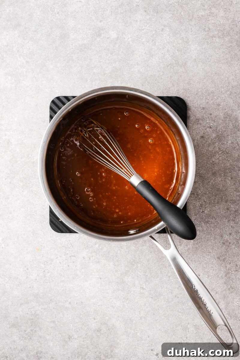 Hoisin Peanut Sauce Recipe for Stir-Fries, Dipping & Marinades 9 Cooked peanut hoisin sauce in a stainless steel saucepan with a homogenous texture.
