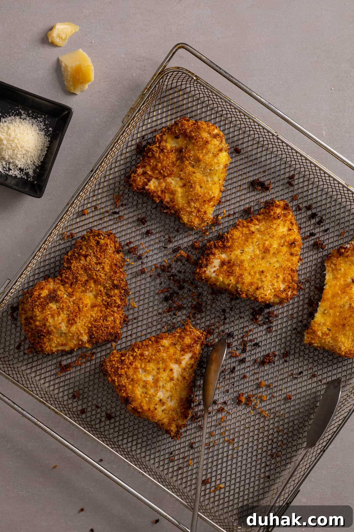 Crispy panko and parm crusted chicken on a wire rack.