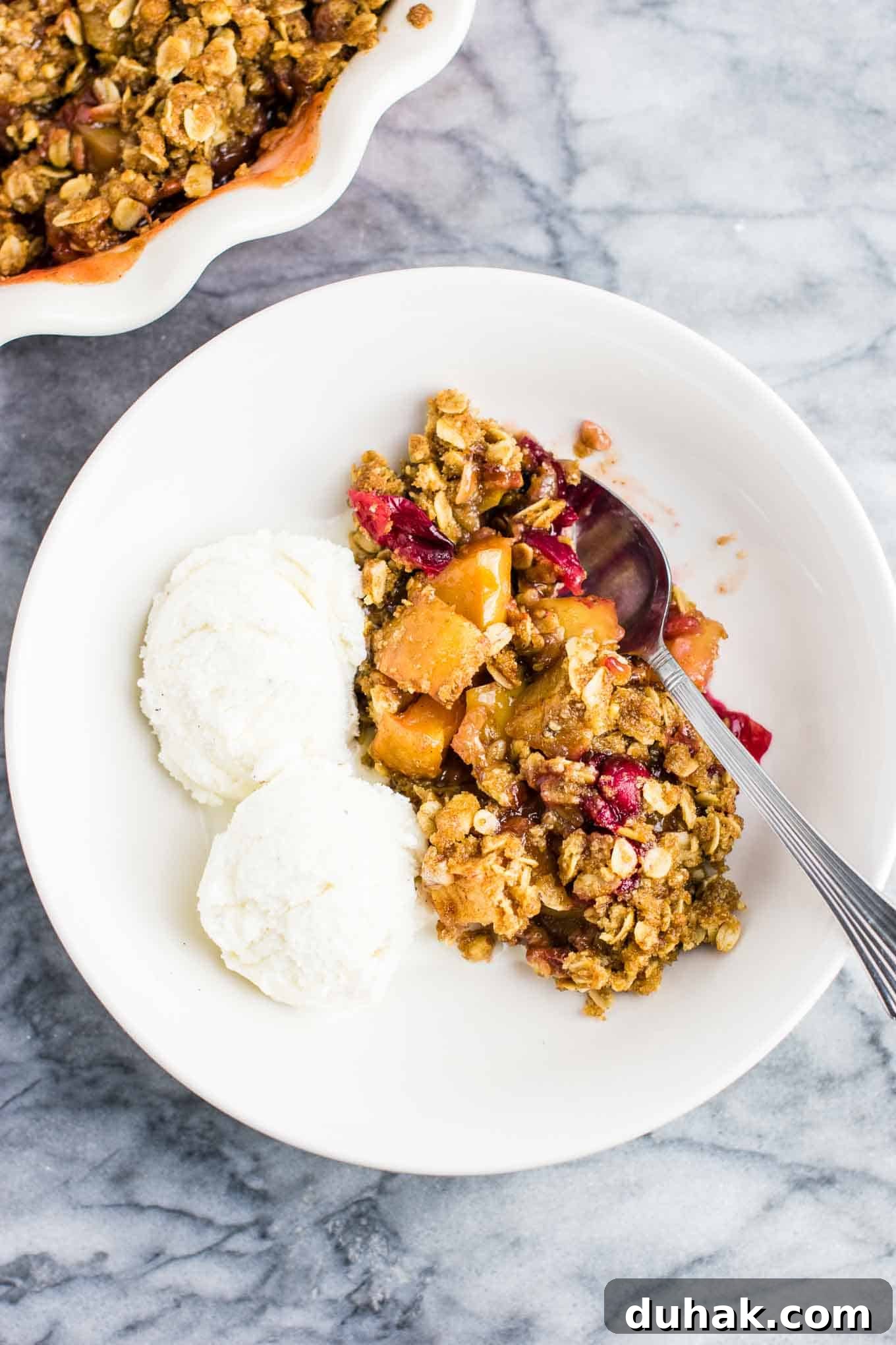 Cranberry Apple Crisp with Warm Cinnamon Crumble 7 cranberry crisp with ice cream in a bowl