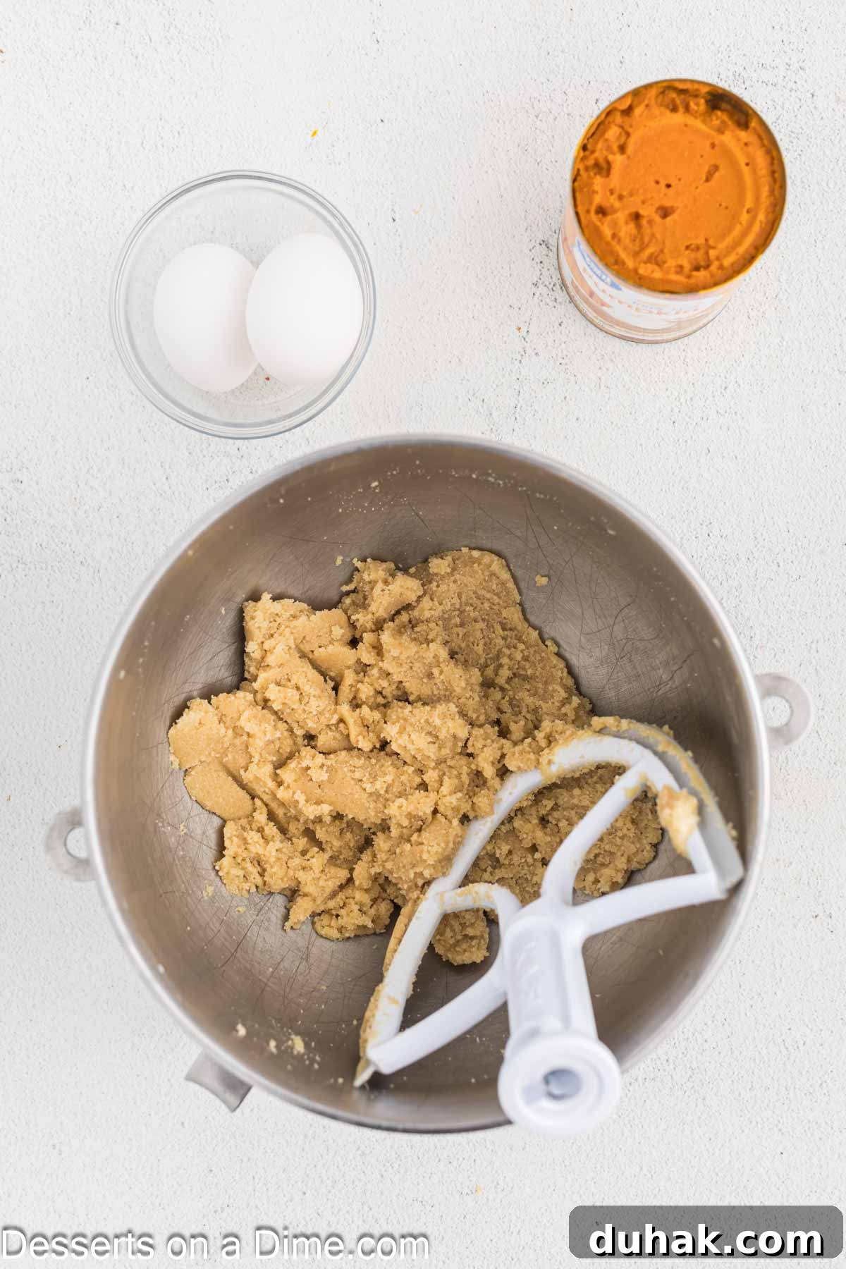 Bowl of stand mixer with butter and both sugars combined. 