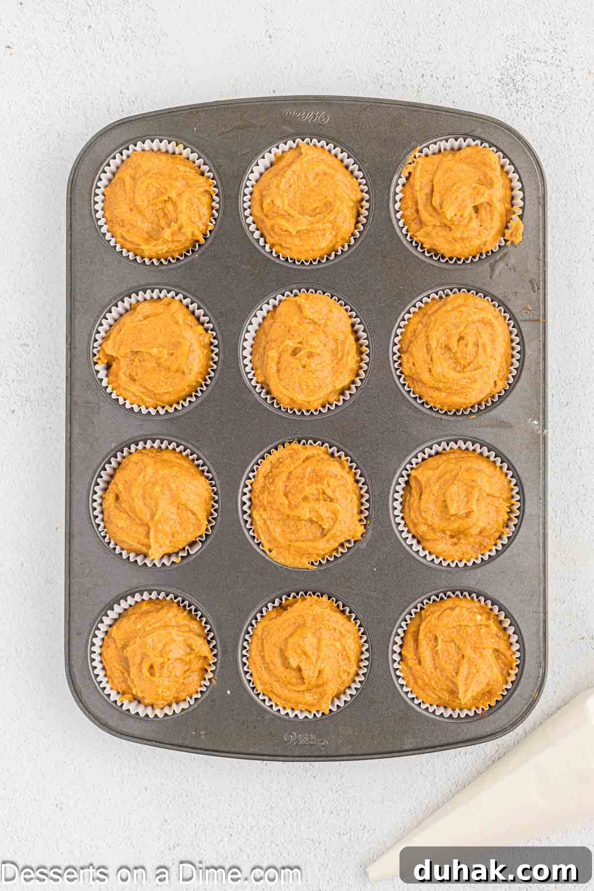 Batter divided into muffin tins. 