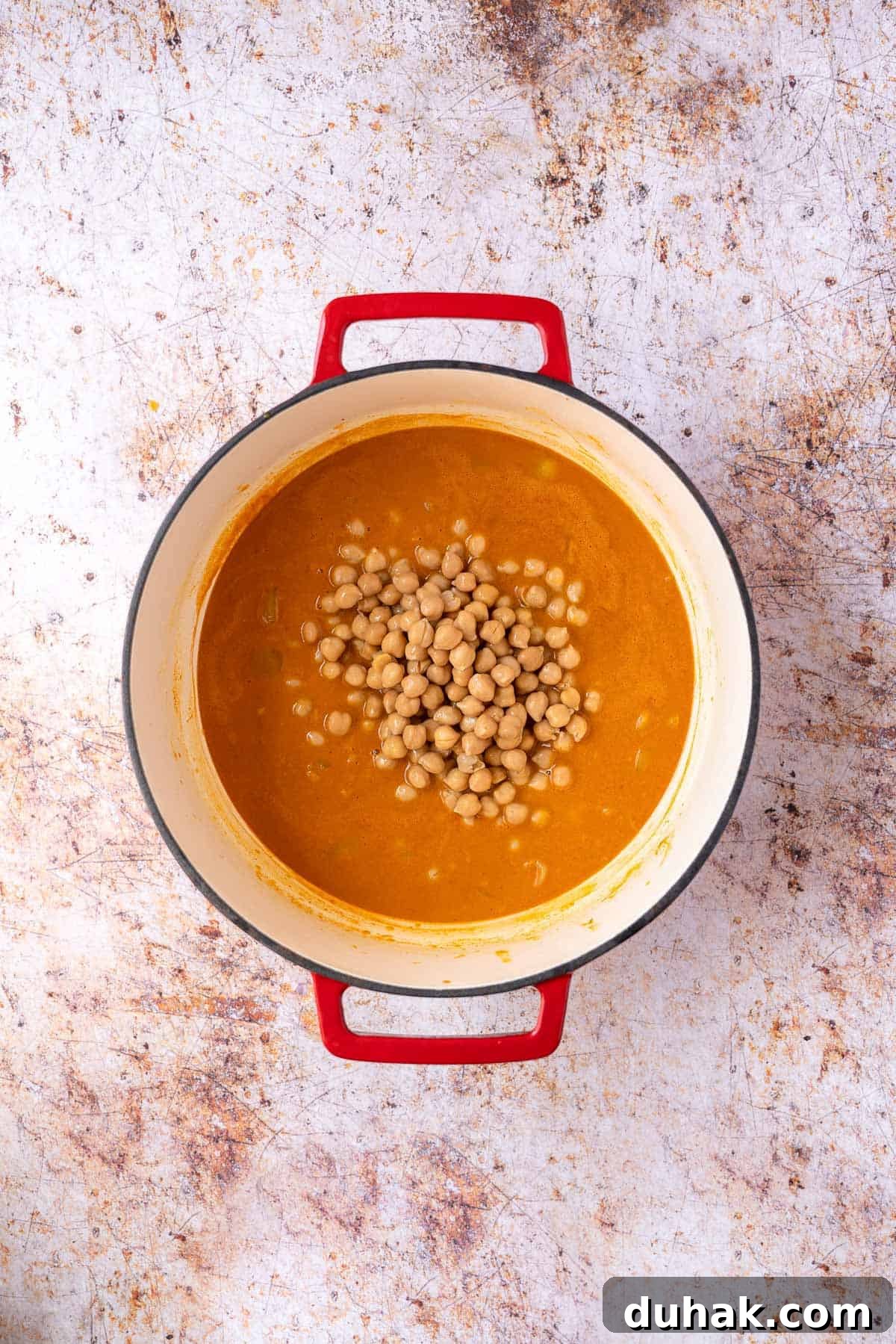 Canned chickpeas added to the pot.