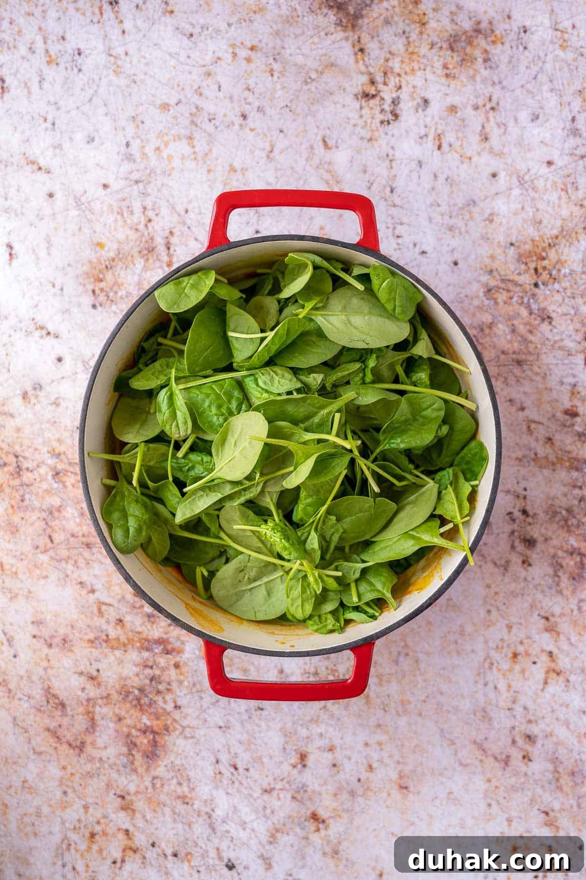 Fresh baby spinach added to pot.