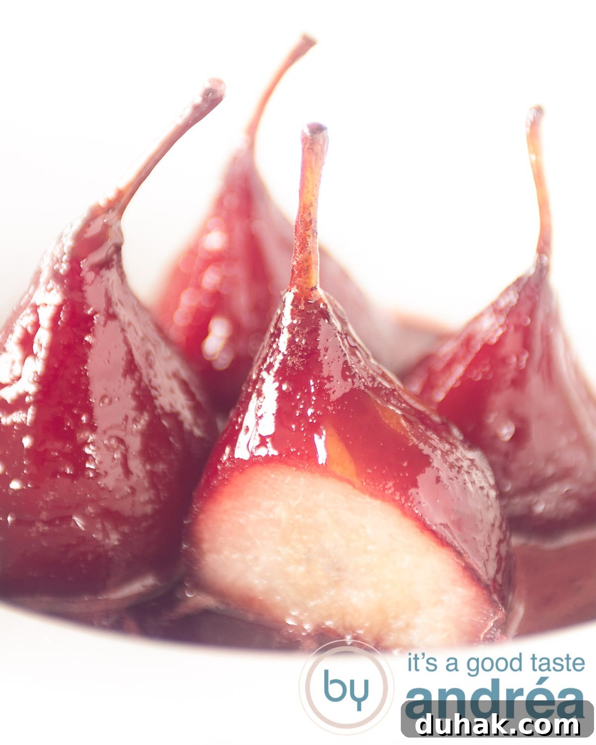 French Port-Poached Pears Recipe — Classic Dessert in Minutes 5 4 stewed Pears au vin rouge aka poached pears with syrup in a white deep plate
