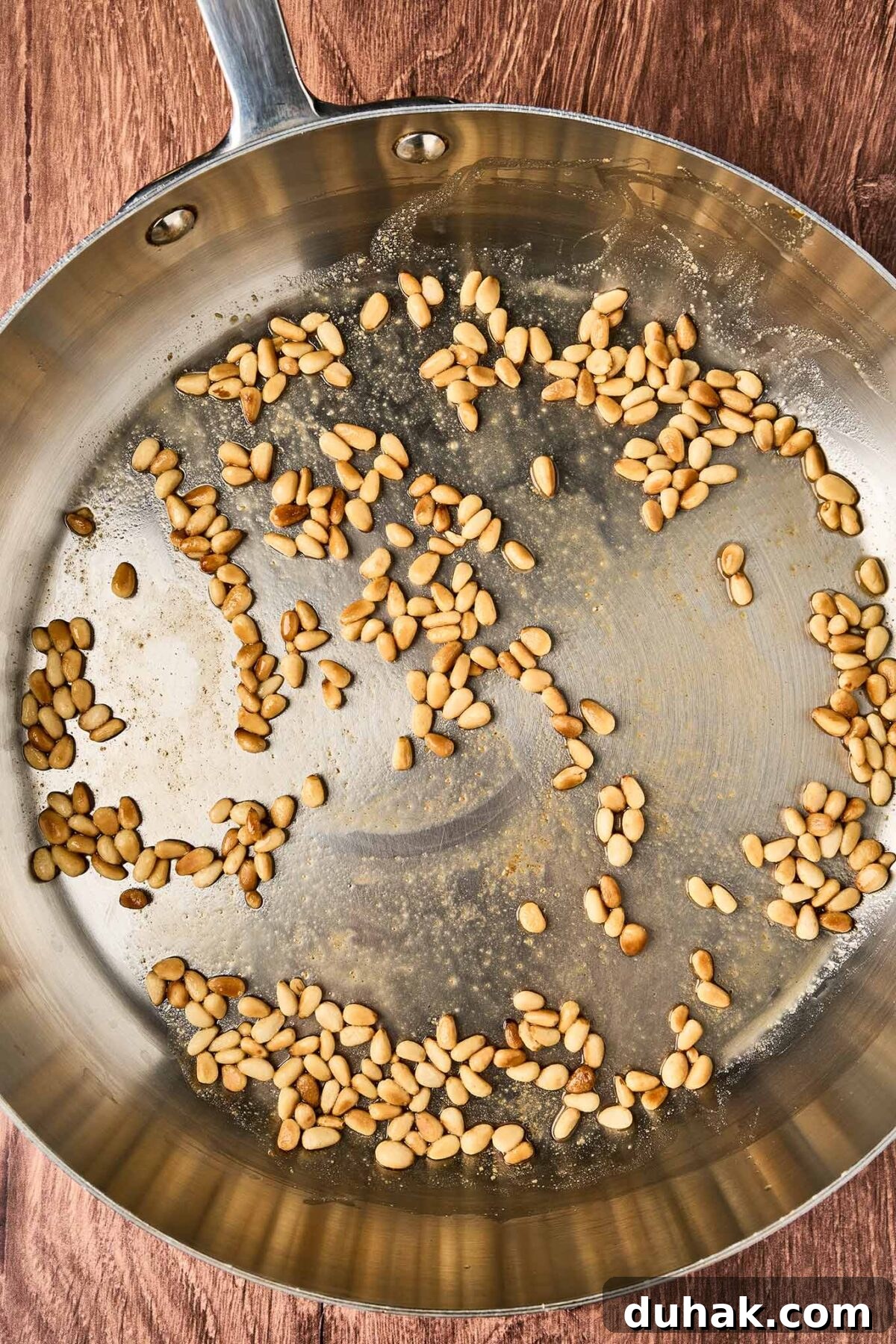 Creamy Goat Cheese Pasta with Fresh Cherry Tomatoes 4 Pine nuts toasting in a skillet for goat cheese pasta with fresh tomatoes.