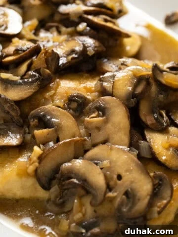 Chicken marsala with mushrooms served over top.