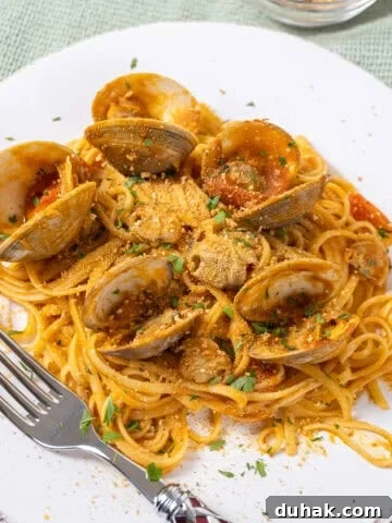 linguine with clams in red sauce on a plate.