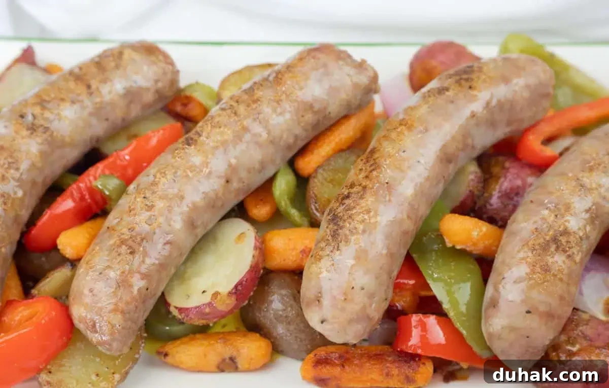 37 Comfort Food Recipes That Keep Reappearing on Menus 23 Four cooked sausages served on a bed of roasted vegetables, including carrots, red potatoes, green bell peppers, and red bell peppers.