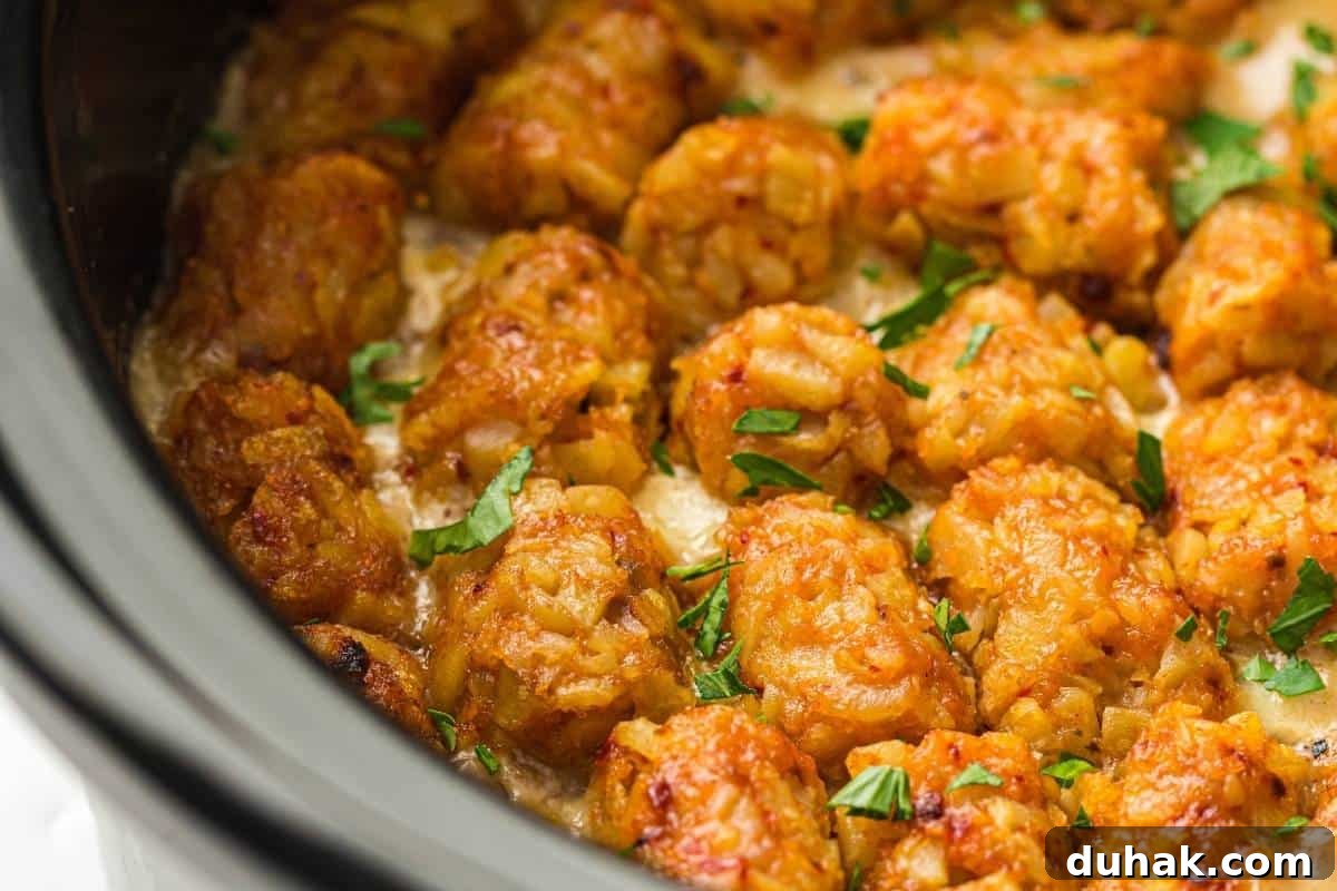 37 Comfort Food Recipes That Keep Reappearing on Menus 35 Close-up of Slow Cooker Cowboy Casserole garnished with chopped parsley, inside a slow cooker.