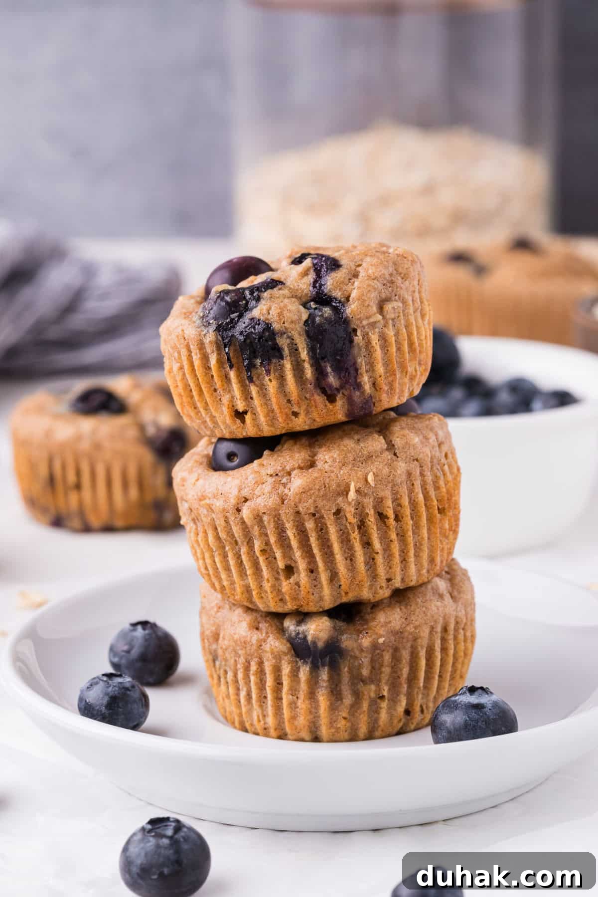 Stack of three blueberry muffins.