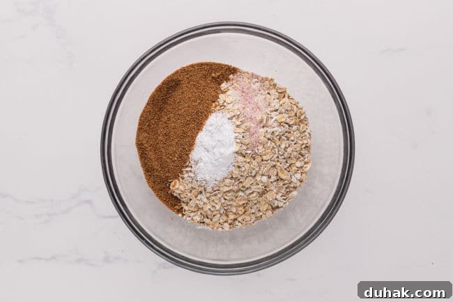Flour, oats, sugar, and baking powder in a bowl.