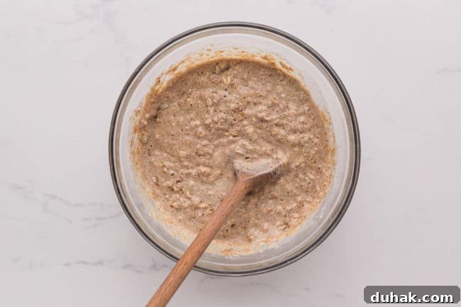 Stirring muffin batter with a wood spoon.