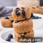 Stack of three blueberry muffins.