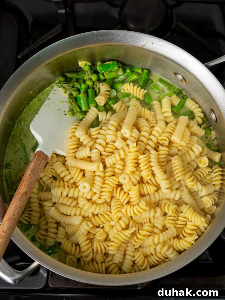 Creamy Salmon Pesto Pasta with Lemon Zest 13 cooked fusilli pasta added to peas, asparagus and creamy pesto sauce