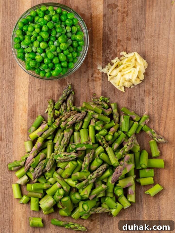 Creamy Salmon Pesto Pasta with Lemon Zest 7 chopped asparagus and garlic, peas in a small bowl