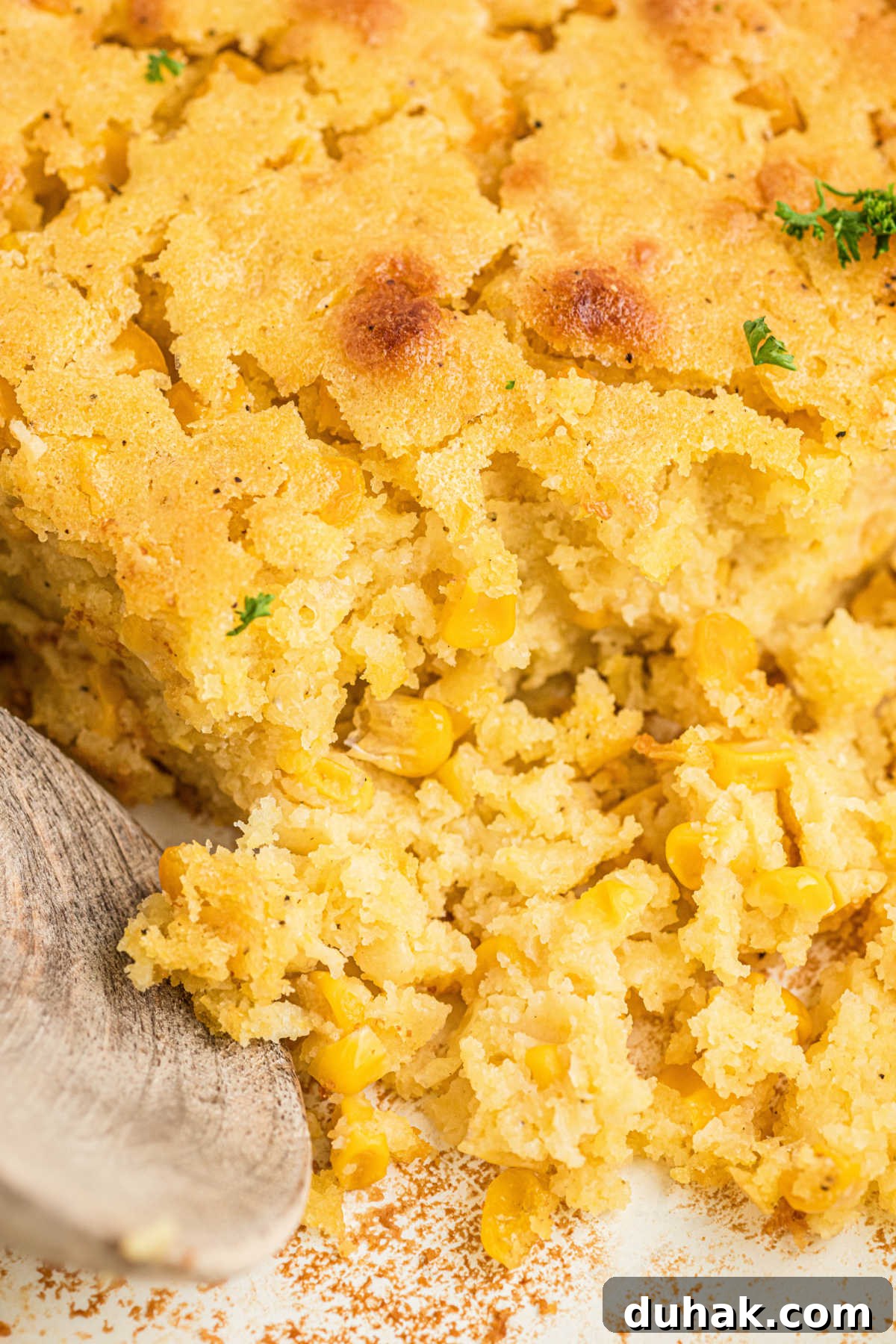 Close up view of a cornbread pudding in a dish.