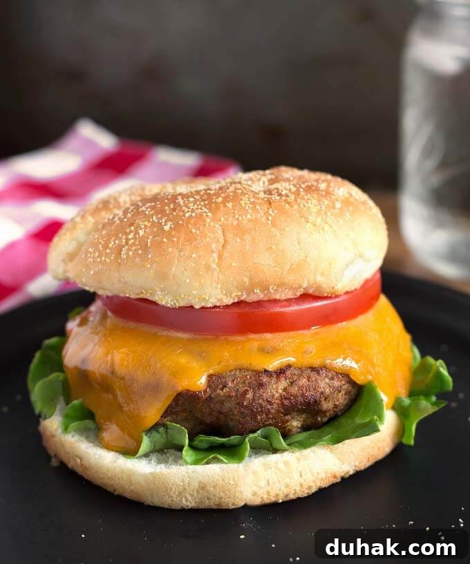Air Fryer Turkey Burger on black plate in front of red gingham napkin
