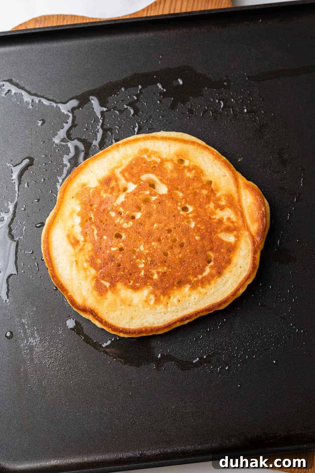 cooking a pancake on a griddle
