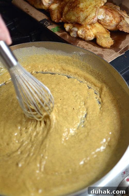 Classic Sausage and Chicken Gumbo Recipe — Hearty Creole Stew 7 Stirring a roux for sausage and chicken gumbo.