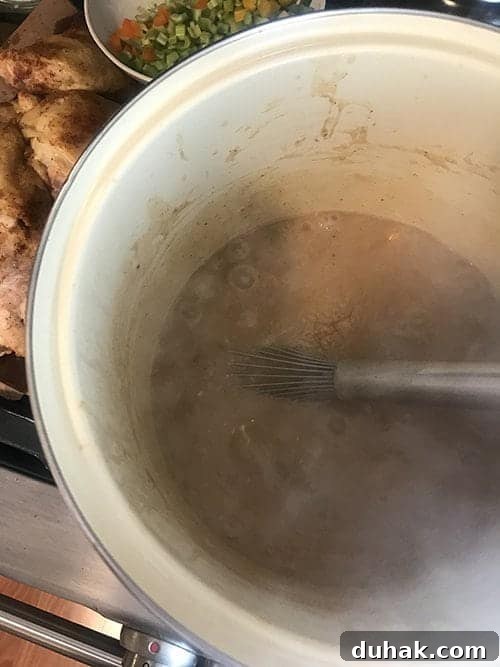 Classic Sausage and Chicken Gumbo Recipe — Hearty Creole Stew 9 Adding roux to make sausage and chicken gumbo.