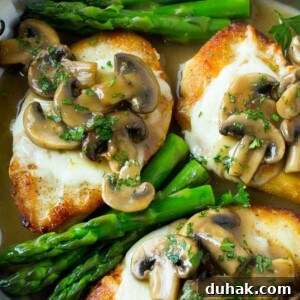 Chicken breasts topped with melted cheese and mushroom sauce.