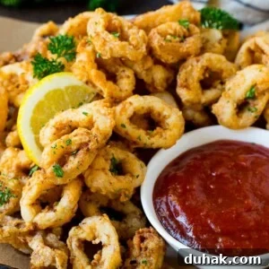 Fried calamari with lemon and sauce.