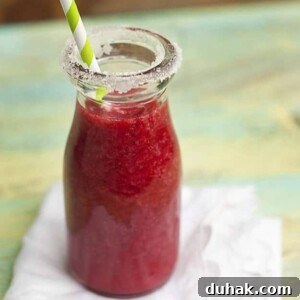 A small bottle of raspberry lemonade.