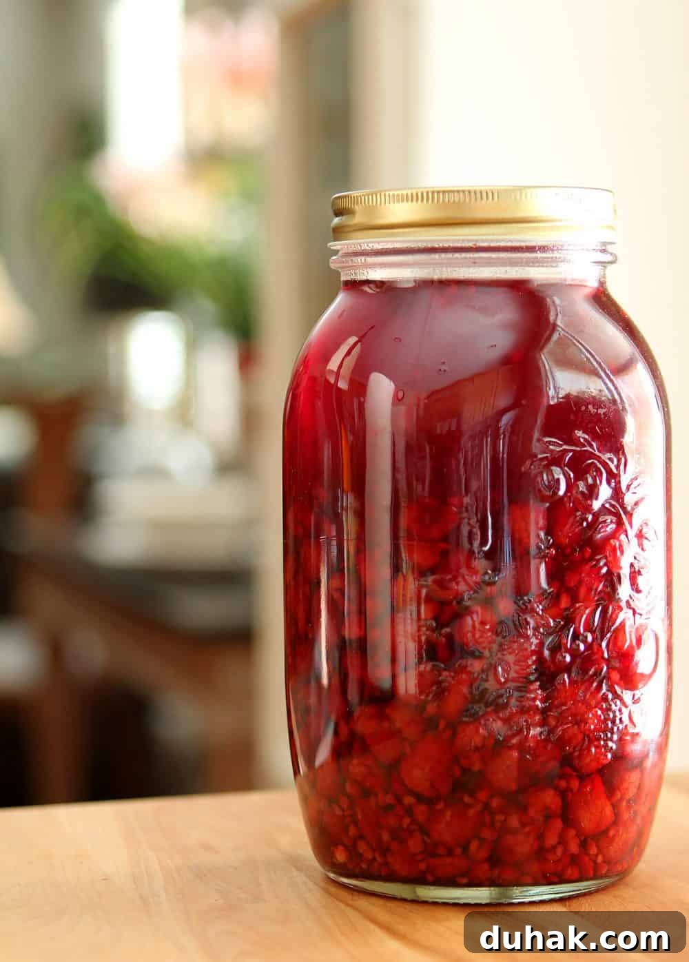 Raspberries are combined with liquor to extract their flavor and the result is a beautiful liqueur.