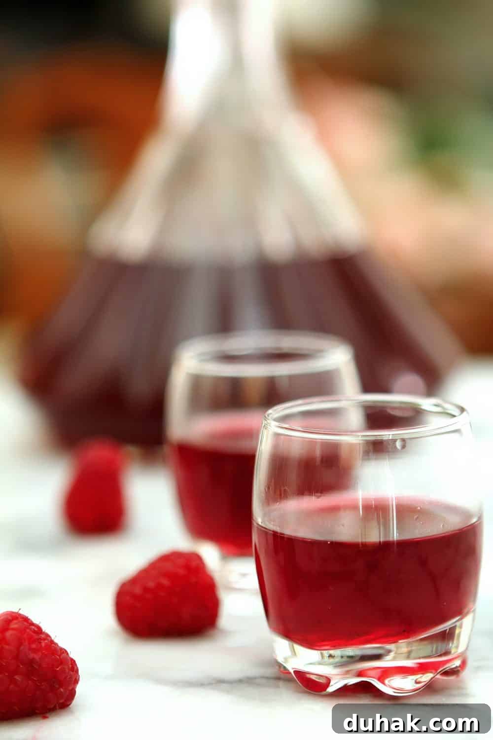 A beautiful deep pink shot of homemade Raspberry Liqueur.