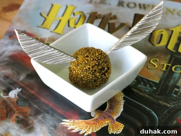 Wings inserted into a Golden Snitch Truffle ball.