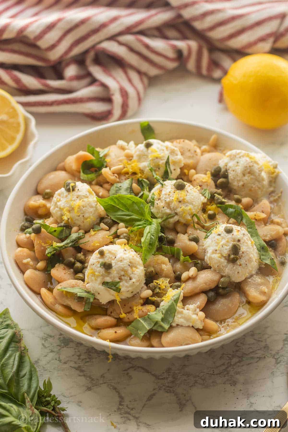 Creamy Ricotta and Butter Bean Salad with Lemon Herb Dressing 2 Butter bean salad with ricotta in bowl with basil.