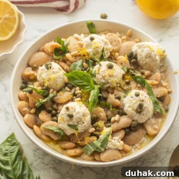 Creamy Ricotta and Butter Bean Salad with Lemon Herb Dressing 14 Butter bean salad with ricotta in bowl with basil.