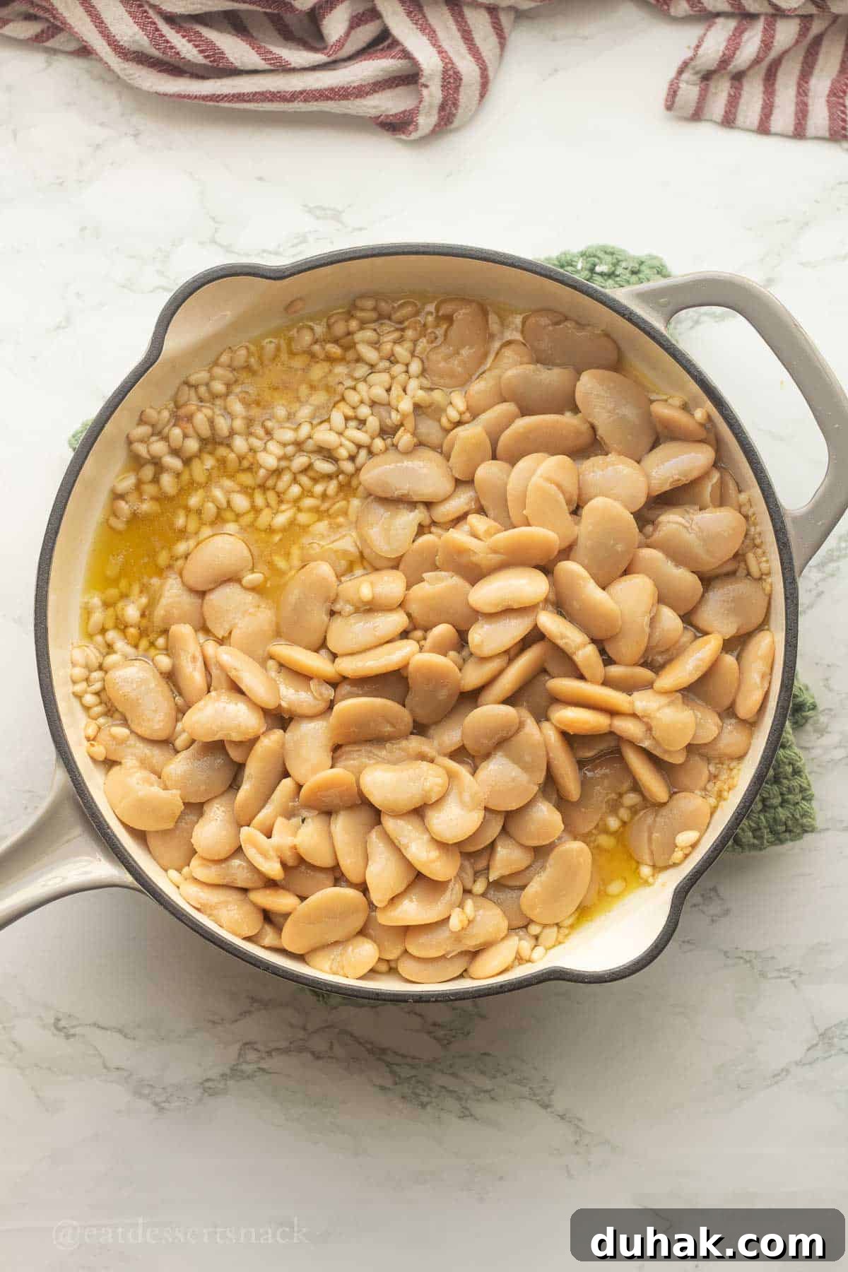 Creamy Ricotta and Butter Bean Salad with Lemon Herb Dressing 6 Butter beans with olive oil and pine nuts in frying pan.