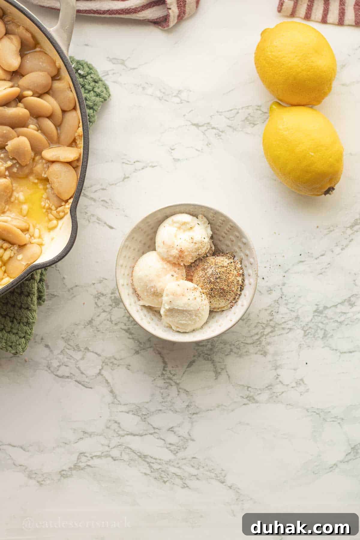 Creamy Ricotta and Butter Bean Salad with Lemon Herb Dressing 7 Ricotta in a bowl with salt and pepper.