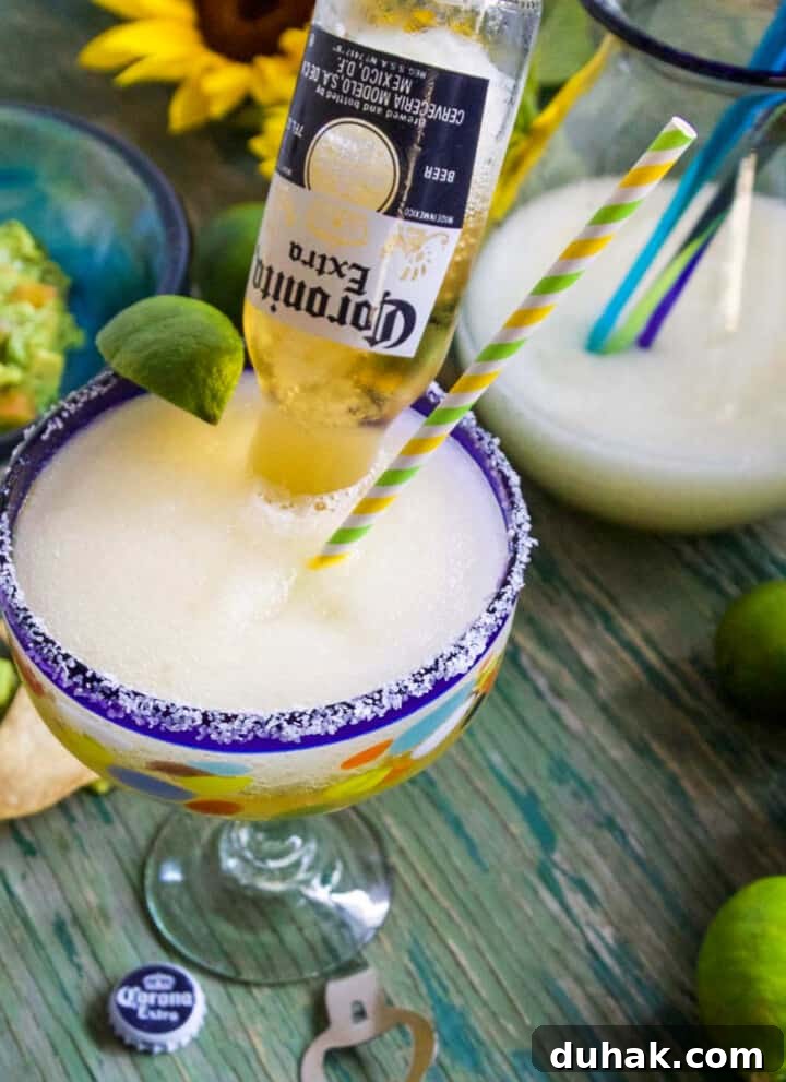 A Cinco de Mayo party with frozen margaritas called Coronaritas, guacamole, and chips on a green table.