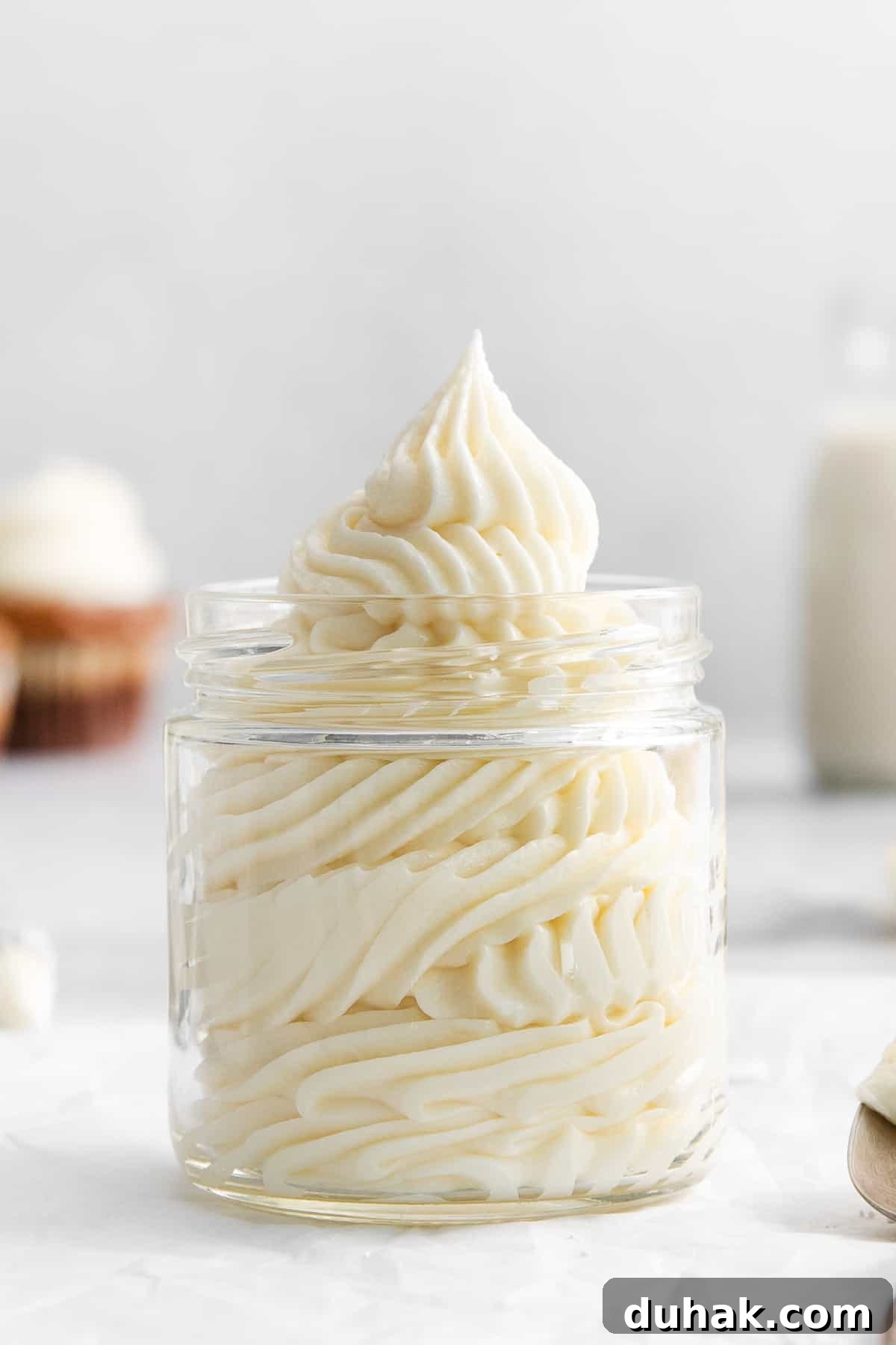 Cream cheese buttercream frosting in a jar.