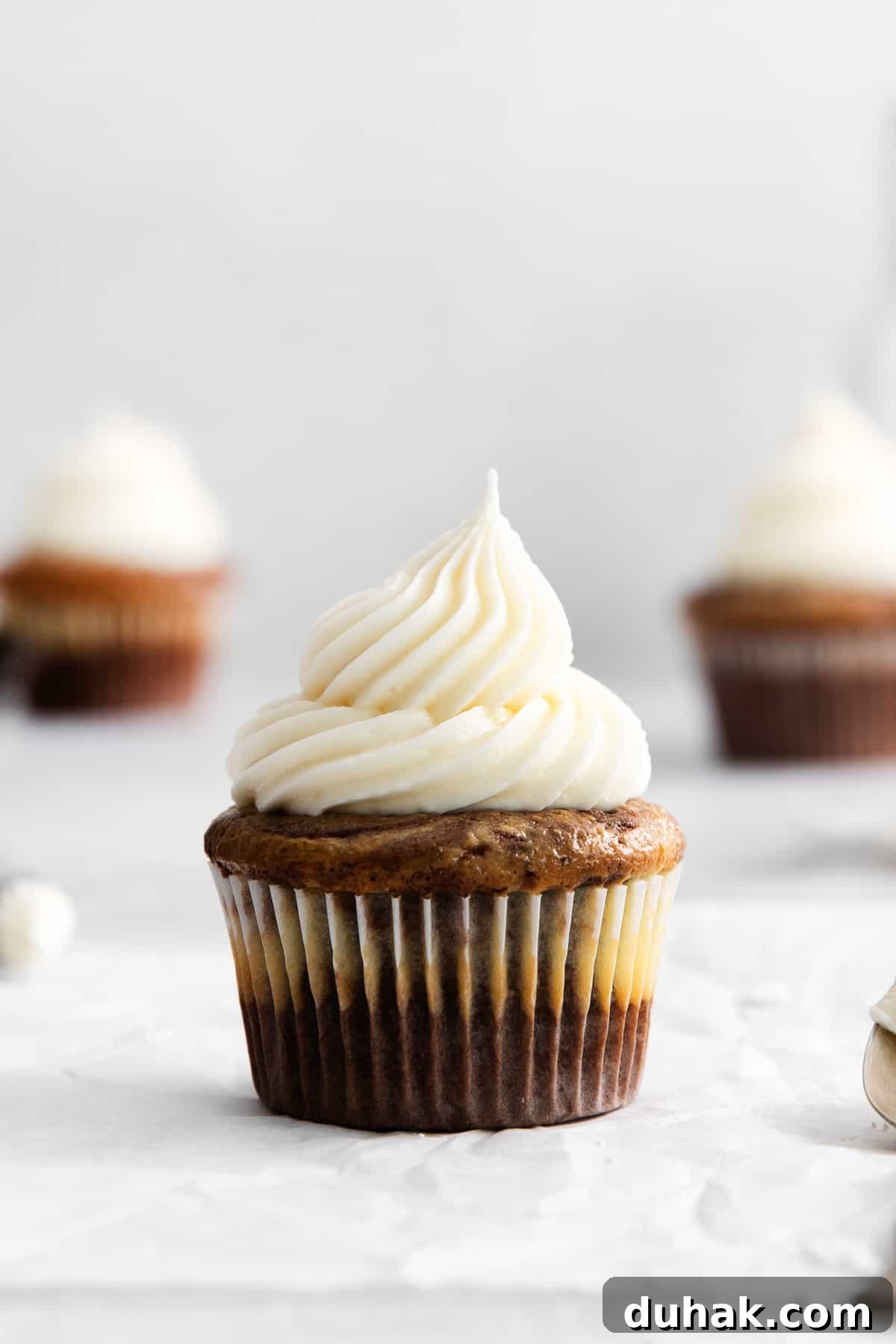 Cream cheese buttercream frosting on a cupcake.